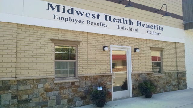 a sign in front of a brick building